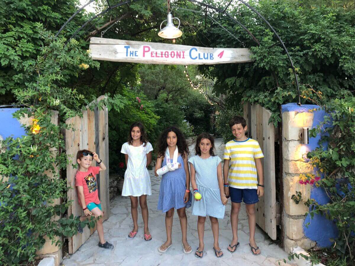 children in front of Peligoni Club entrance